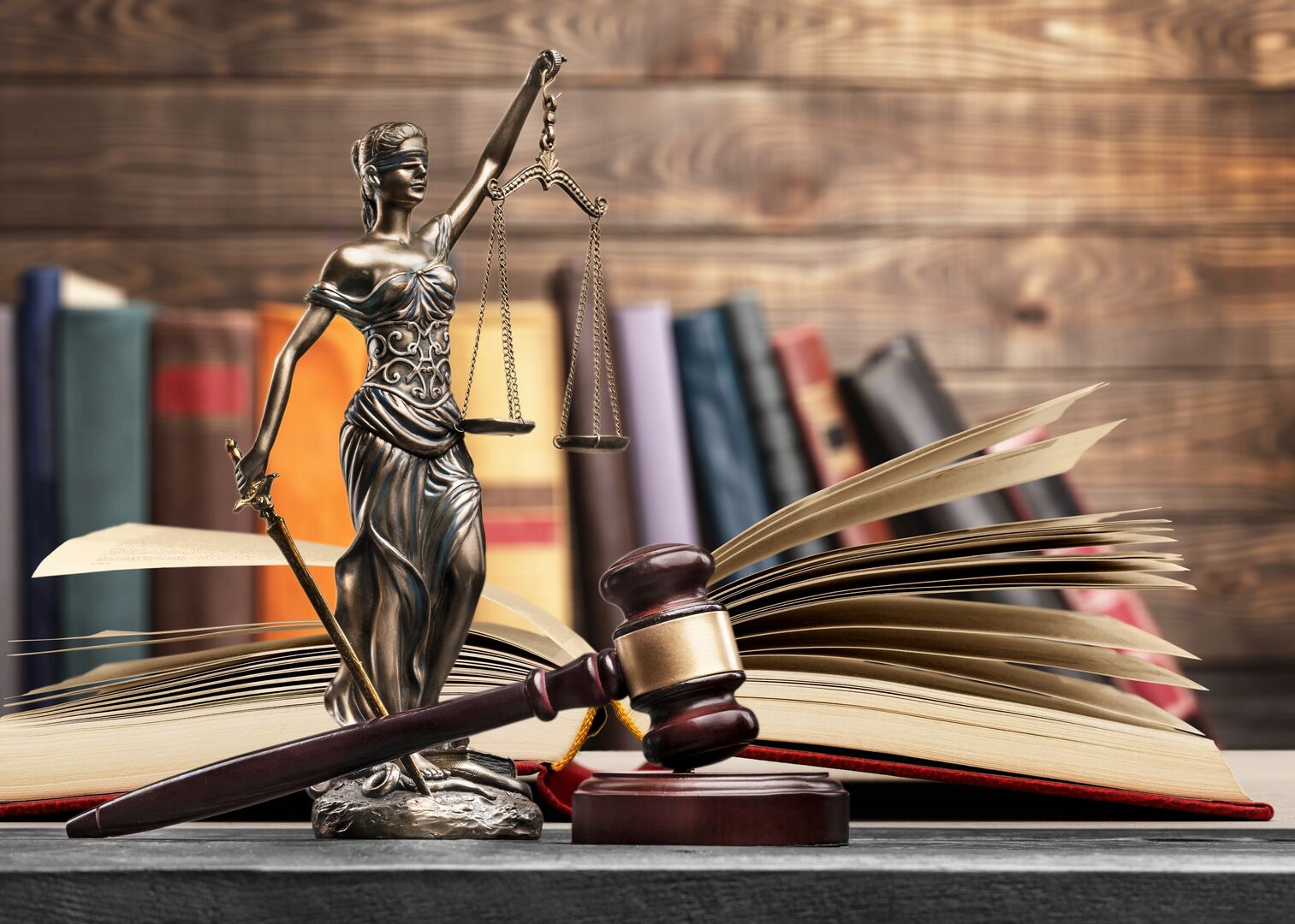Sculpture justice bronze lady and open books and gavel Sculpture justice bronze lady and open books and gavel