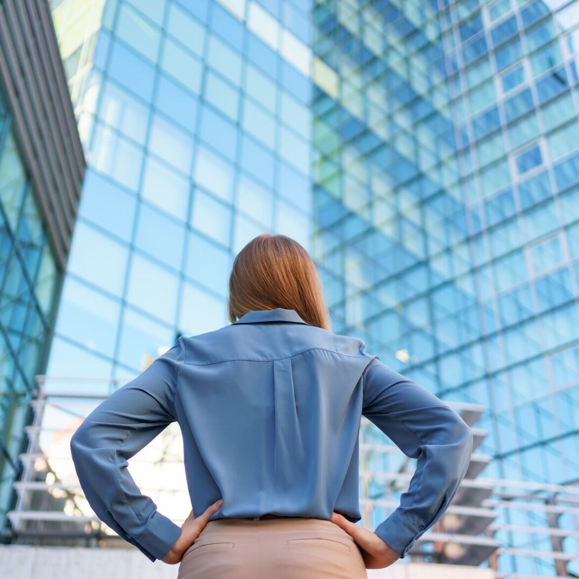 Back view woman looking business building